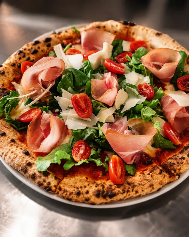 A Margherita pizza fresh out of the wood-fired oven